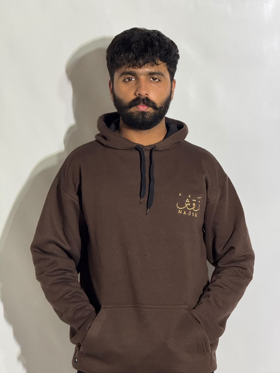 Naqsh Chocolate Brown Embroidered Hoodie for Men – Premium Fleece Pullover with Golden Urdu Calligraphy Logo & Kangaroo Pocket